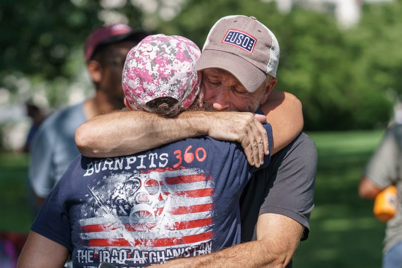 Activist and entertainer Jon Stewart hugs fellow advocate Susan Zeier of Sandusky, Ohio, just after Senate Majority Leader Chuck Schumer, D-N.Y., assured veterans and military family members that the Senate will vote on a bill designed to help millions of veterans exposed to toxic substances during their military service, at the Capitol in Washington, Aug. 2, 2022.