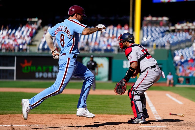 Philadelphia Phillies' Nick Castellanos scores past Washington Nationals catcher Keibert Ruiz during the eighth inning of a baseball game, Aug. 7, 2022, in Philadelphia.