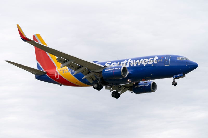 A Southwest Airlines flight prepares to land at Reagan National Airport, in Arlington, Va., Monday, Dec. 27, 2021. A Southwest Airlines flight attendant suffered a compression fracture to a vertebra in her upper back during a hard landing in July 2022 in California, according to federal safety investigators.