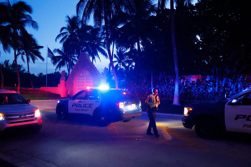Police direct traffic outside an entrance to former President Donald Trump's Mar-a-Lago estate