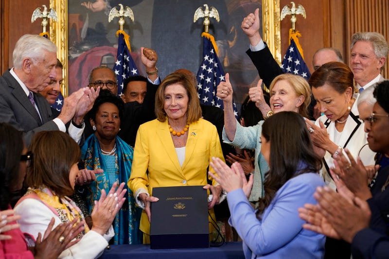 House Speaker Nancy Pelosi of Calif., surrounded by House Democrats, poses after signing the Inflation Reduction Act of 2022 during a bill enrollment ceremony on Capitol Hill in Washington, Friday, Aug. 12, 2022. 