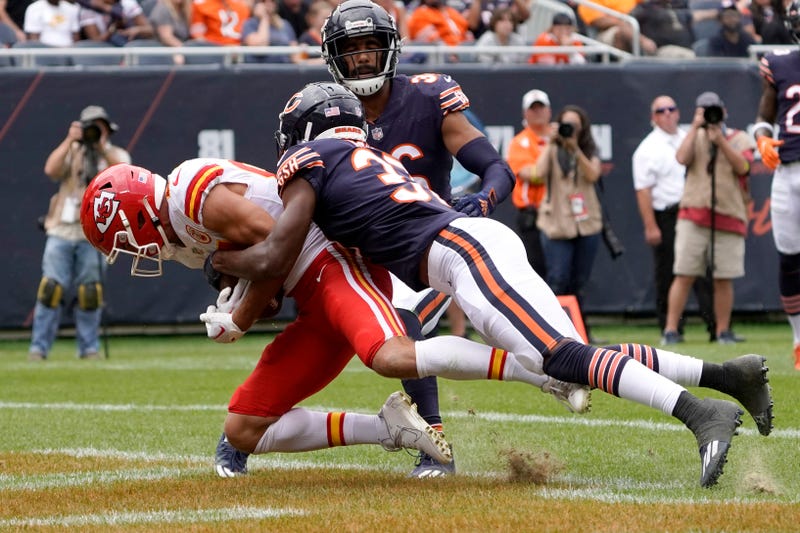 Two Chicago Bears payers tackle a player on the Kansas City Chiefs
