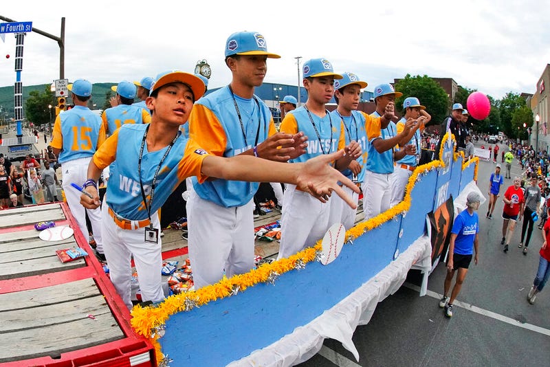 The West Region champion Little League team from Honolulu rides in the Little League Grand Slam Parade in downtown Williamsport, Pa., Monday, Aug. 15, 2022. The Little League World Series baseball tournament, featuring 20 teams from around the world, starts on Wednesday in South Williamsport, Pa.