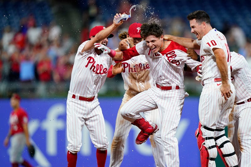 Philadelphia Phillies' Nick Maton celebrates with teammates after hitting a game-winning RBI-single against Cincinnati Reds pitcher Alexis Diaz during the ninth inning of a baseball game, Tuesday, Aug. 23, 2022, in Philadelphia. 