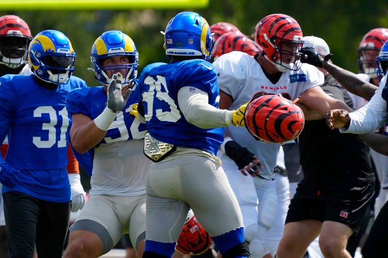 Los Angeles Rams defensive tackle Jonah Williams (92) attempts to hold back Rams defensive tackle Aaron Donald (99) as a third scuffle escalates into a brawl during a joint preseason NFL football camp practice between the Cincinnati Bengals and the Rams in Cincinnati, Thursday, Aug. 25, 2022. Practice was ended early after the third scuffle turned into a broader fight between players on both teams.