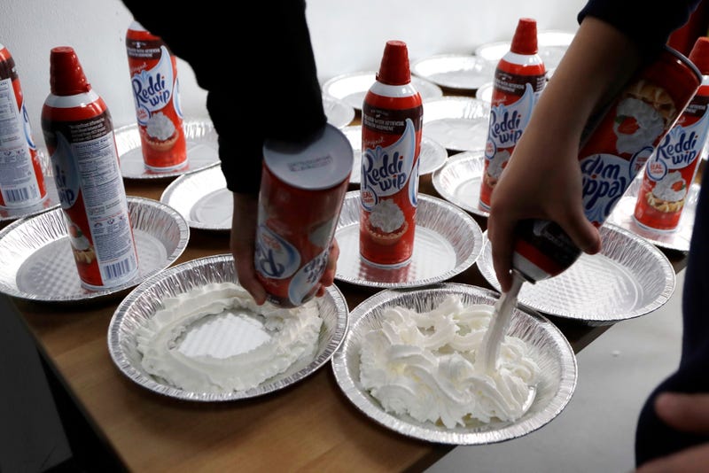 Students prepare whipped cream pies before a celebration of pi at the Hamtramck Academy Tuesday, March 14, 2017, in Hamtramck, Mich. On Friday, Sept. 2, 2022, The Associated Press reported on stories circulating online incorrectly claiming a New York law that aims to crack down on nitrous oxide abuse makes it illegal for anyone under age 21 to purchase a can of whipped cream.
