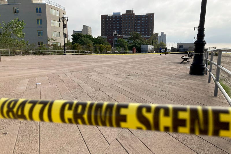 Crime scene tape stretches across a section of the Coney Island boardwalk near a stretch of beach where three children were found dead in the surf, Monday, Sept. 12, 2022, in New York.