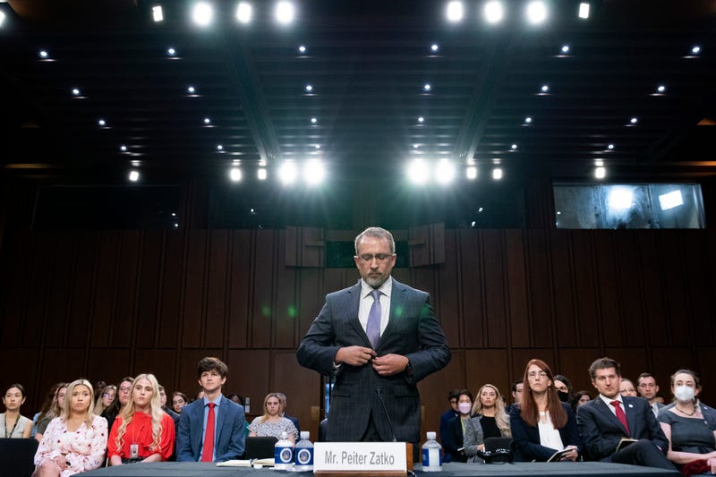 CORRECTS SPELLING FROM PETER TO PEITER - Twitter whistleblower Peiter Zatko buttons his jacket as he rises to be sworn in to testify to a Senate Judiciary hearing examining data security at risk, Tuesday, Sept. 13, 2022, in Washington.