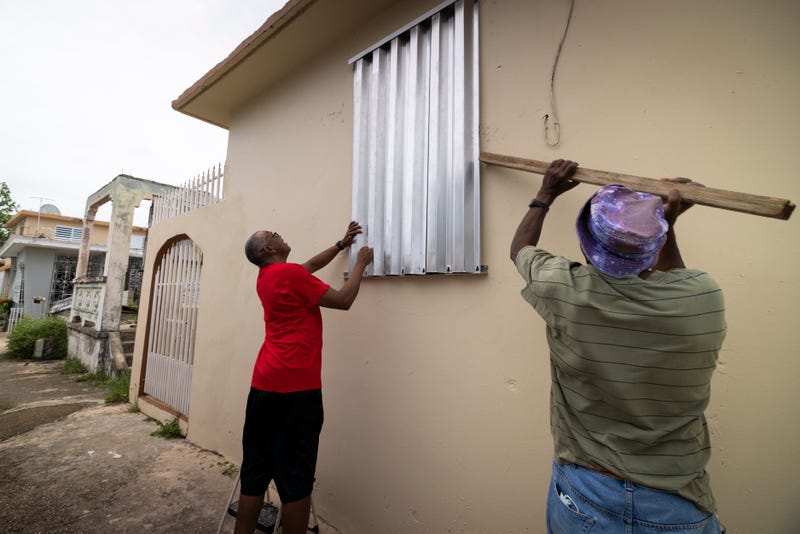 Residents prepare for the arrival of Fiona, in Loiza, Puerto Rico, Saturday, Sept. 17, 2022.