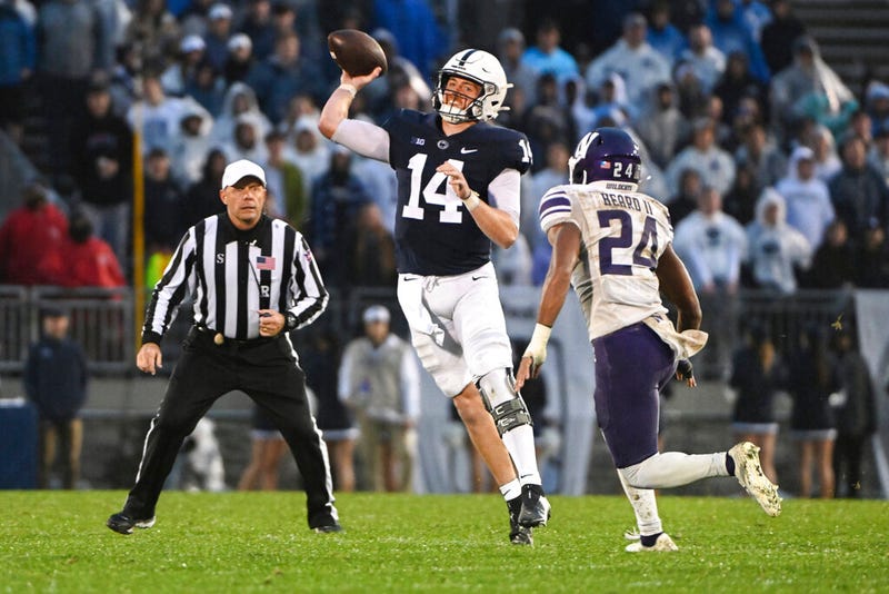Penn State quarterback Sean Clifford (14) throws a pass while being pressured by Northwestern defensive back Rod Heard II (24) during the second half of an NCAA college football game Saturday, Oct. 1, 2022, in State College, Pa.