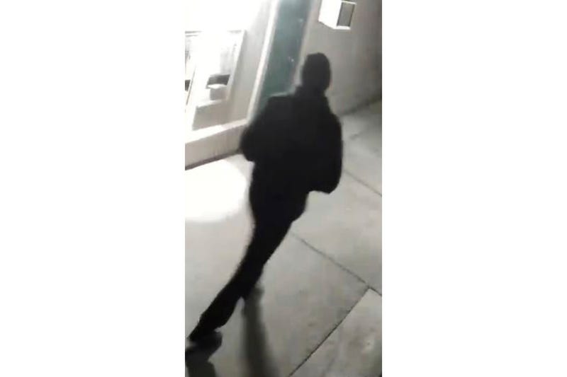 In this undated surveillance image released by the Stockton Police Department, a person is shown from behind, in Stockton, Calif. Rewards totaling $85,000 have been offered for information leading to an arrest in five fatal shootings since July in Stockton, California, that investigators believe are related, police said. After reviewing surveillance footage, detectives have located an unidentified “person of interest” in the killings, Stockton Police Chief Stanley McFadden wrote on the department’s Facebook page. Police released a grainy still image of an individual filmed from behind, dressed all in black and wearing a black cap.