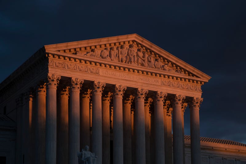 The Supreme Court is seen at sunset in Washington, on Jan. 24, 2019. The Supreme Court will hear arguments on Oct. 11, 2022, over a California animal cruelty law that could raise the cost of bacon and other pork products nationwide.