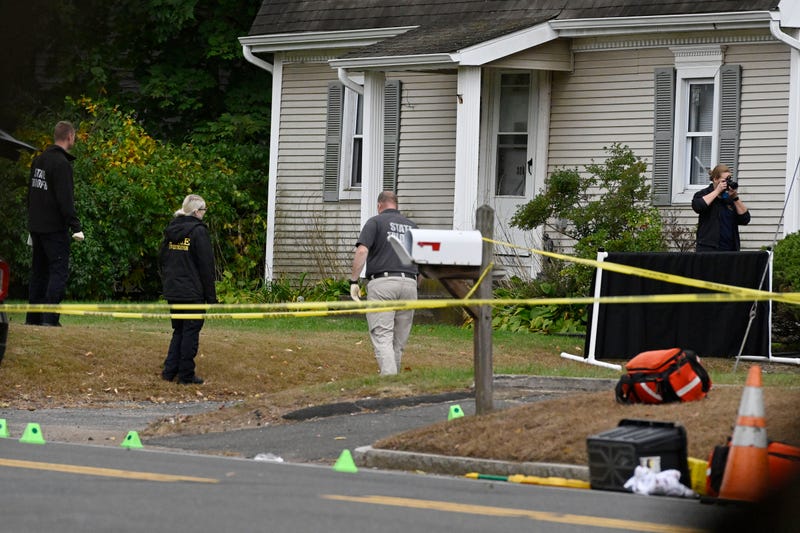 Police investigate the scene where two police officers were killed the night before in Bristol, Conn., Thursday, Oct. 13, 2022