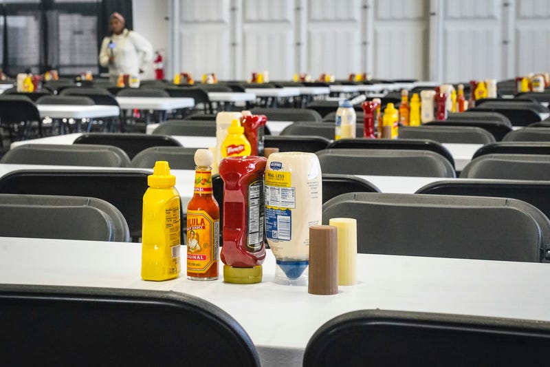 Tables set with condiments for scores of individuals, shown during a media tour, is part of New York City's latest temporary shelter on Randall's Island for migrants being bused into the city by southern border states, Oct. 18, 2022