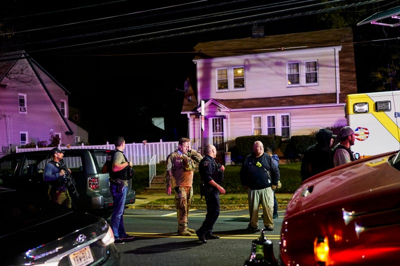 Law enforcement personnel gather at the scene where two officers were reported shot, Tuesday, Nov. 1, 2022, in Newark, N.J