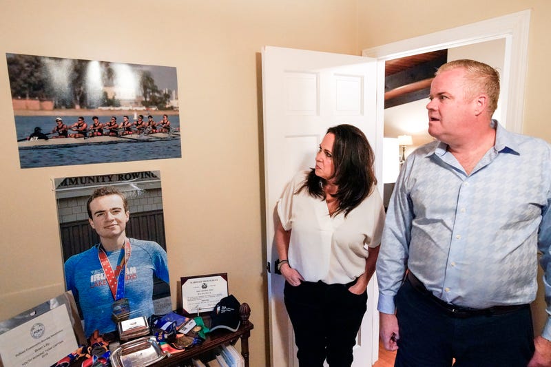 Brenda and Brian Lilly look at photos of their son Brian Lilly Jr. in their Easton, Conn. home, Thursday, Oct. 13, 2022. Brian Lilly Jr., 19, who committed suicide on Jan. 4, 2021, was a rower at University of California San Diego. The Lillys have filed a wrongful death lawsuit against the university and the rowing coach, Geoff Bond, who is no longer with the school.