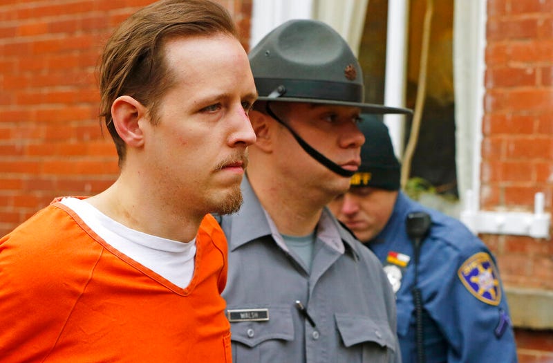 FILE – Eric Frein, left, is escorted out by police after his arraignment at the Pike County Courthouse on Oct. 31, 2014, in Milford, Pa. The parents of Frein, a gunman who killed a Pennsylvania state trooper and permanently disabled another eight years ago in an ambush of a police barracks have settled a lawsuit that accused them of partial responsibility for the attack. A Lackawanna County judge was to hear arguments on the motion Oct. 31, 2022, but court documents indicate that he was advised that the case had been settled, the Wilkes-Barre Citizens' Voice reported.