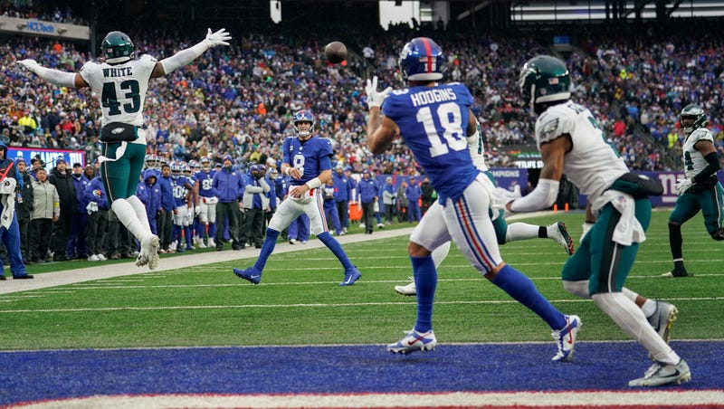 New York Giants quarterback Daniel Jones (8) completes a pass to wide receiver Isaiah Hodgins (18) for a touchdown against the Philadelphia Eagles during the second quarter of an NFL football game, Sunday, Dec. 11, 2022, in East Rutherford, N.J.