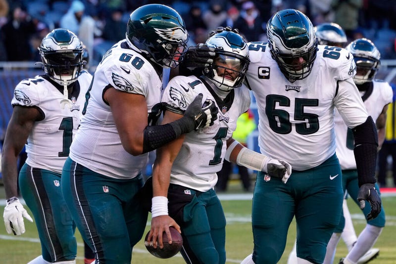 Philadelphia Eagles' Jalen Hurts (1) celebrates with Lane Johnson (65) and Jordan Mailata (68) after running for a two-point conversion during the second half of an NFL football game against the Chicago Bears, Sunday, Dec. 18, 2022, in Chicago. 