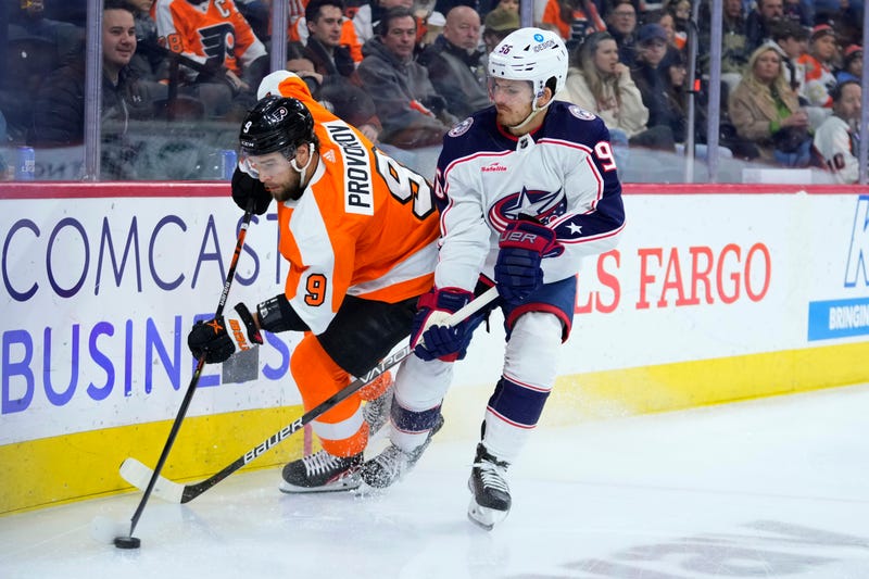 Philadelphia Flyers' Ivan Provorov, left, and Columbus Blue Jackets' Jack Roslovic battle for the puck during the first period of an NHL hockey game, Tuesday, Dec. 20, 2022, in Philadelphia. 