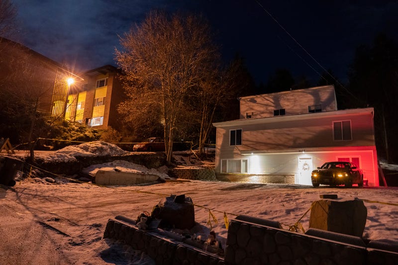 A private security officer sits in a vehicle, Tuesday, Jan. 3, 2023, in front of the house in Moscow, Idaho where four University of Idaho students were killed in November, 2022.