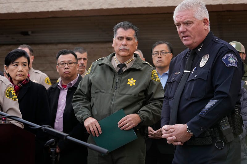 Los Angeles County Sheriff Robert Luna, at podium, briefs the media outside the Civic Center in Monterey Park, Calif., Sunday, Jan. 22, 2023. Monterey Park Mayor Henry Lo, second from right. A mass shooting at a Los Angeles-area ballroom dance club following a Lunar New Year celebration, set off a manhunt for the suspect.