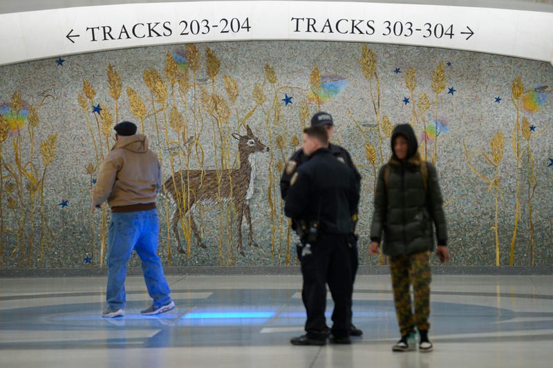 People walks past a mural in the new annex in Grand Central Station in New York, Wednesday, Jan. 25, 2023. (AP Photo/Seth Wenig)