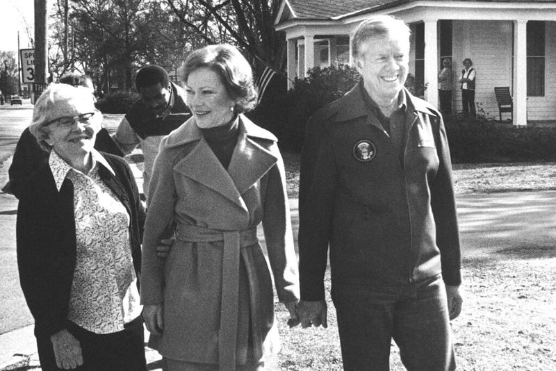 Former President Jimmy Carter walks home with Rosalynn Carter and her mother, Allie Smith, from their office on Jan. 23, 1981, in Plains, Georgia.