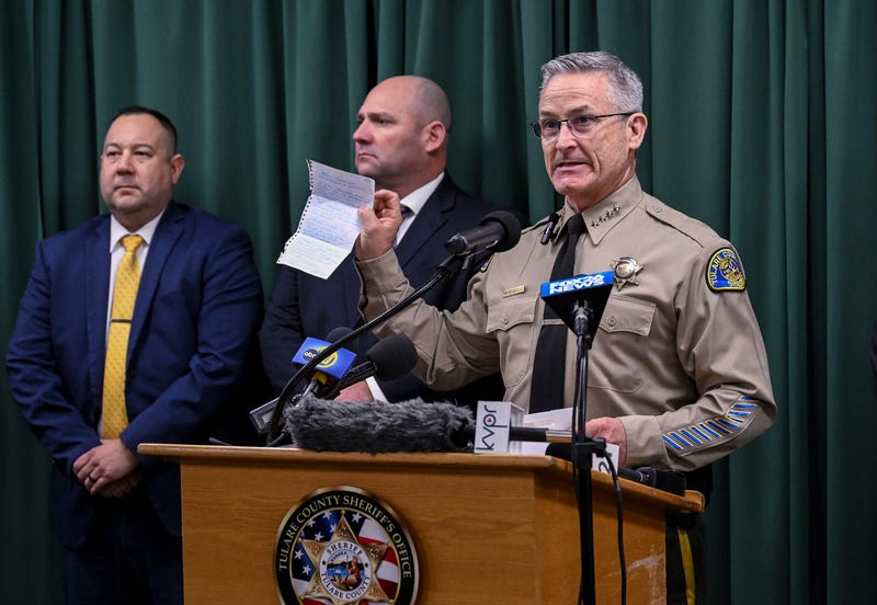 Tulare County Sheriff Mike Boudreaux holds a letter Monday, Jan. 30, 2023, from a Maine woman that sent $100 to add to the reward offered for information about a mass shooting that occurred January 16, in Goshen, Calif. No arrests were announced but autopsies confirmed that all six victims died from gunshot wounds.