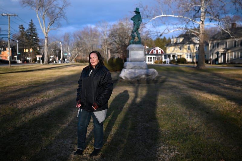 In this Tuesday, Jan. 24, 2023 photo, Beth Caruso, author and co-founder of the CT Witch Trial Exoneration Project, which was created to clear the names of the accused, stands on the old town green in Windsor, Conn., where in 1651, an accident during a local militiamen training exercise led to the accusation of witchcraft and hanging of Lydia Gilbert