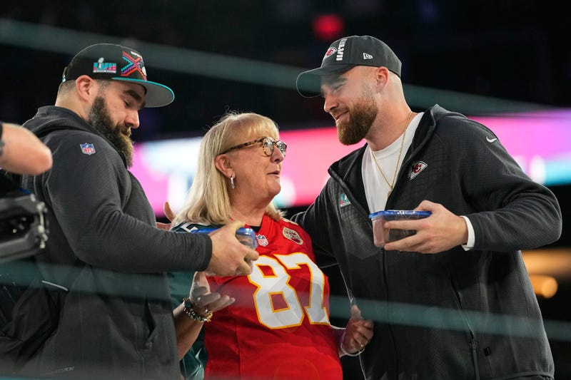Donna Kelce greets her sons, Philadelphia Eagles center Jason Kelce, left, and Kansas City Chiefs tight end Travis Kelce during the NFL football Super Bowl 57 opening night, Feb. 6, 2023, in Phoenix.