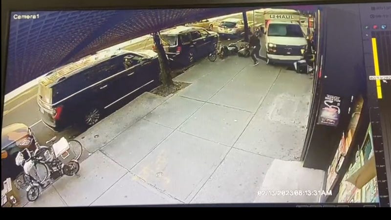 In this photo taken from security video, a man jumps out of the way as a U-Haul truck drives onto the sidewalk on Feb. 13, 2023, in Brooklyn