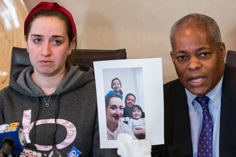 Lawyer Derek Sells holds a picture next to Nadjet Tchenar, the wife of Mohammed Zakaria Salah Rakchi, one of the victims of the U-Haul rampage, as they speak to the media during a press conference on Tuesday, Feb. 14, 2023, in New York