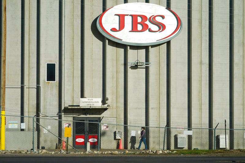 A worker heads into the JBS meatpacking plant in Greeley, Colo.