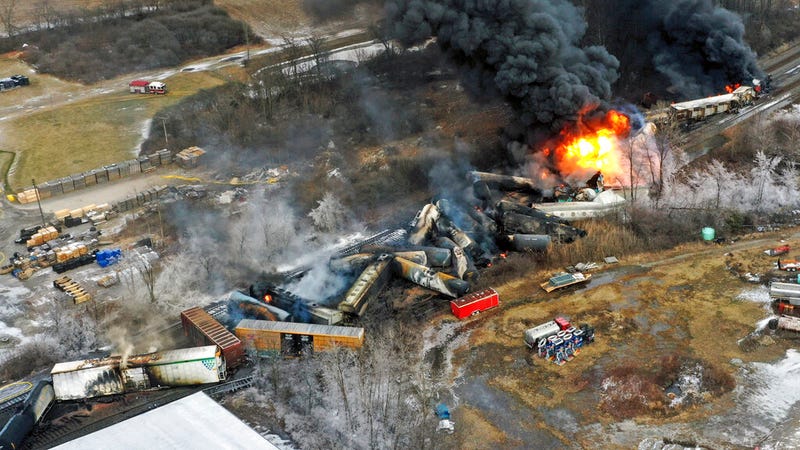 Portions of a Norfolk Southern freight train that derailed the previous night in East Palestine, Ohio, remain on fire at mid-day on Feb. 4, 2023.