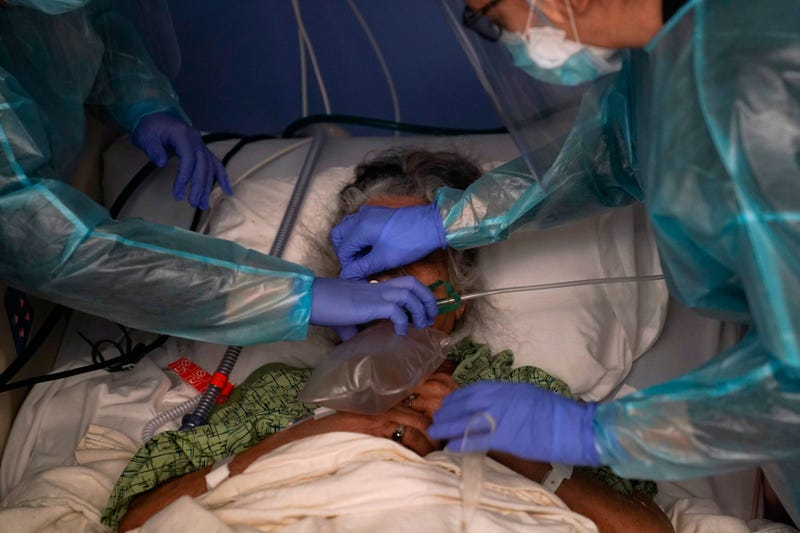 Two nurses put a ventilator on a patient in a COVID-19 unit at St. Joseph Hospital in Orange, Calif. Thursday, Jan. 7, 2021. California's COVID-19 emergency declaration ends on Tuesday, Feb. 28, 2023. Gov. Gavin Newsom first issued the emergency declaration on March 4, 2020. The emergency ends just as California officially passed 100,000 COVID-related deaths during the pandemic.
