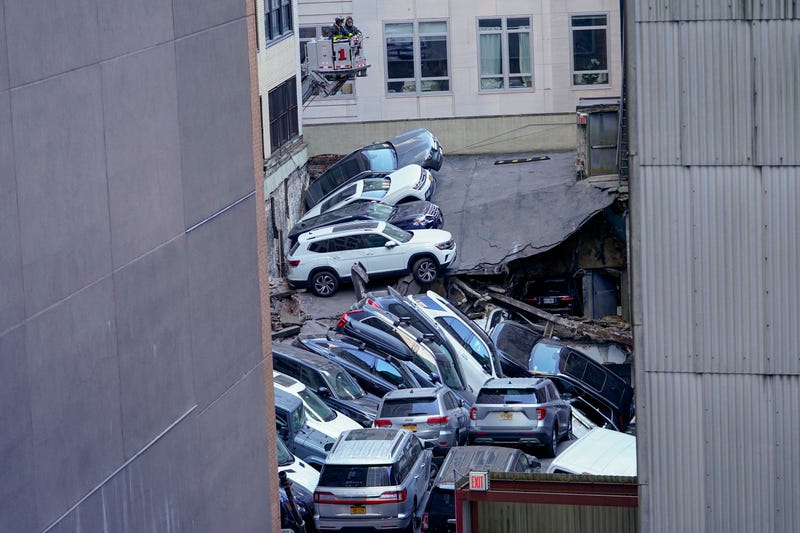 Cars are seen piled on top of each other at the scene of a partial collapse of a parking garage in the Financial District of New York, Tuesday, April 18, 2023, in New York