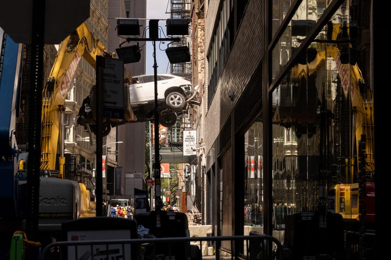 A car is removed from a partially collapsed parking garage in the Financial District of New York on April 19, 2023