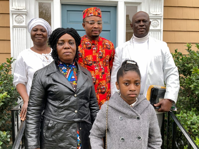 From left, Mary Dwumfour, Afua Sefa, Peter Ezechukwu, Nicole Teliano and Prince Dwumfour pose for a portrait in front of a law office in Sayreville, N.J., April 5, 2023