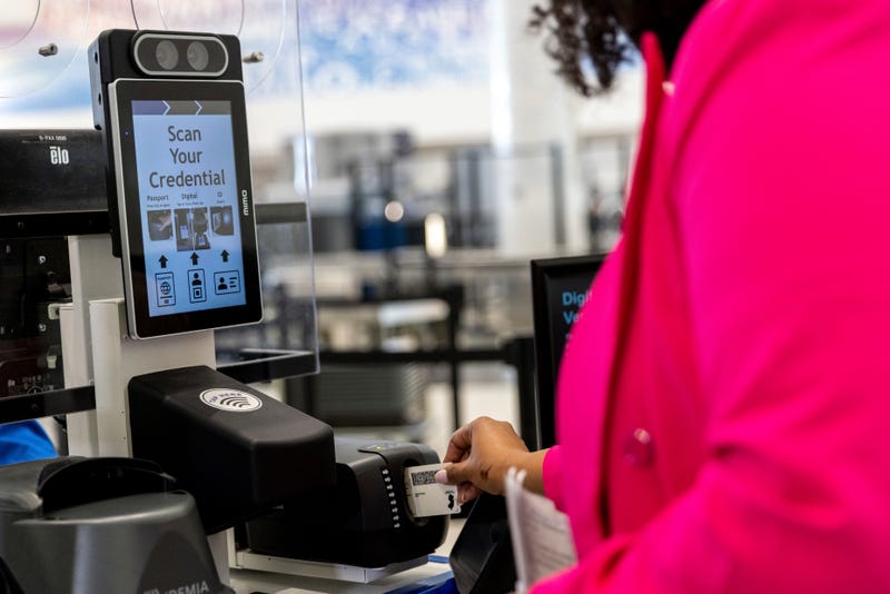 A person inserts an ID card while demonstrating the Transportation Security Administration's new facial recognition technology at a Baltimore-Washington International Thurgood Marshall Airport security checkpoint, Wednesday, April 26, 2023, in Glen Burnie, Md.