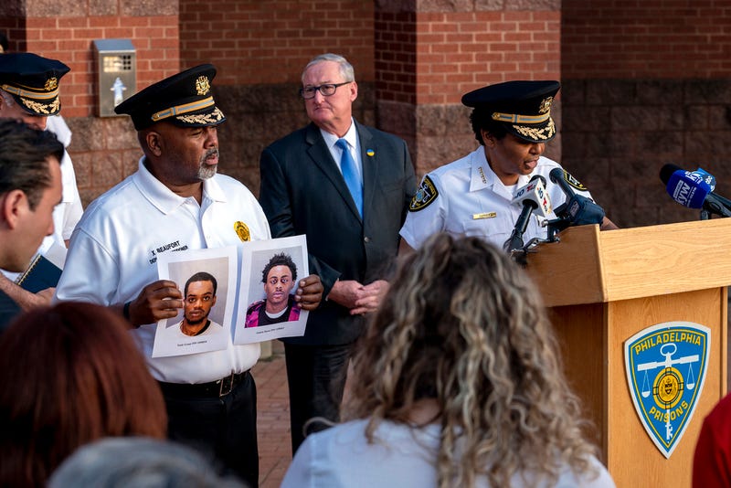 Department of Prisons Commissioner Blanche Carney, right, updates news media outside the Philadelphia Philadelphia Industrial Correctional Center Monday, May 8, 2023, on the recent escape of two prisoners as Mayor Jim Kenney is in rear, and Xavier Beaufort, left, Deputy Prisons Commissioner holds photos of the two escapees.