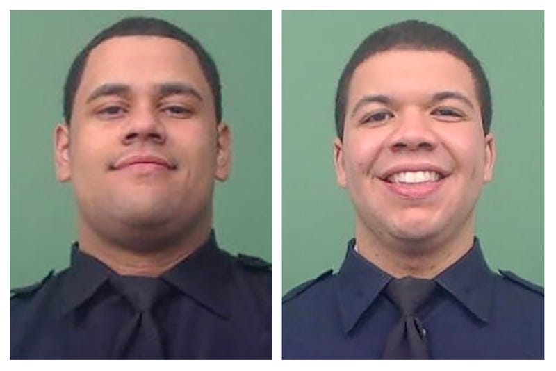This photo combo of images provided by the New York City Police Department shows NYPD Officers Wilbert Mora, left, and Jason Rivera