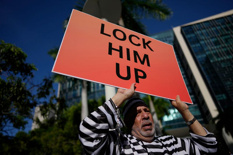 Domenic Santana stands outside the Wilkie D. Ferguson Jr. U.S. Courthouse, Tuesday, June 13, 2023, in Miami. Former President Donald Trump is making a federal court appearance today on dozens of felony charges accusing him of illegally hoarding classified documents and thwarting the Justice Department's efforts to get the records back.