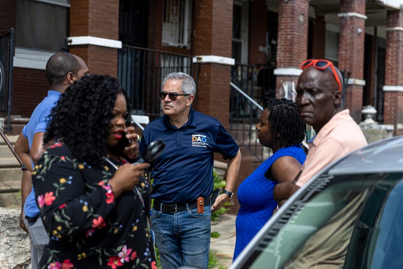 District Attorney Larry Krasner and other officials walk through Kingsessing the day after a mass shooting there.
