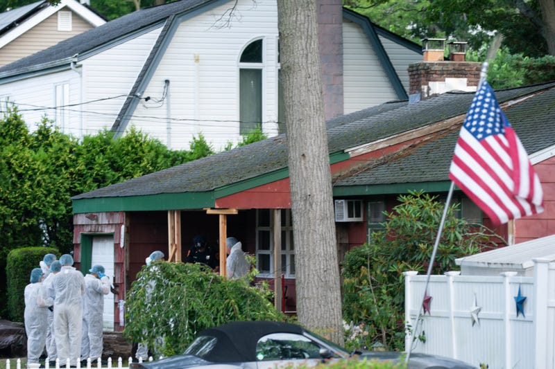 Crime lab officers arrive at the house where a suspect was taken into custody in Massapequa on July 14, 2023