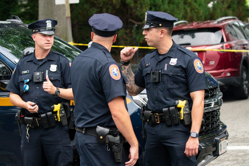 Police officers stand guard near the house where a suspect has been taken into custody on New York's Long Island in connection with a long-unsolved string of killings, known as the Gilgo Beach murders, Friday, July 14, 2023, in Massapequa Park, N.Y.