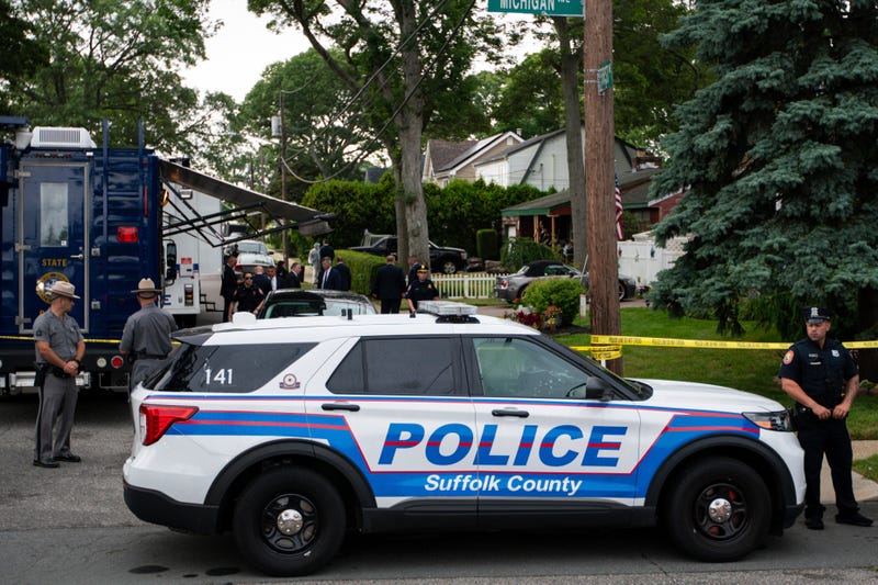 Police officers stand guard near the house where a suspect has been taken into custody on New York's Long Island in connection with a long-unsolved string of killings, known as the Gilgo Beach murders, Friday, July 14, 2023, in Massapequa Park, N.Y.