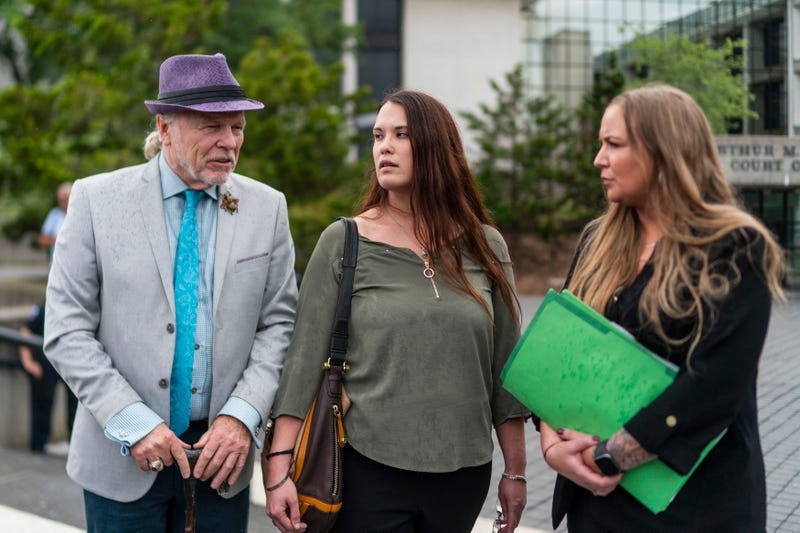 Attorney, John Ray, left, and Jasmine Robinson, center, cousin of Jessica Taylor, a victim of a Long Island serial killer, exit the Arthur M. Cromarty Court Complex, on Friday, July 14, 2023, in Riverhead, N.Y