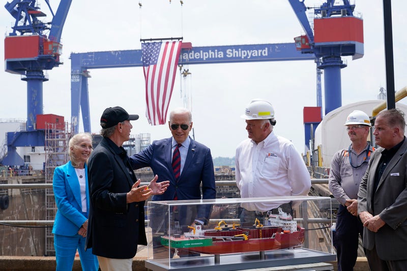 President Joe Biden talks with Lasse Petterson, CEO of Great Lakes Dredge and Dock, second from left, as he tours a shipyard in Philadelphia, Thursday, July 20, 2023. Rep. Mary Gay Scanlon, D-Pa., left, and Steinar Nerbovik, CEO of Philadelphia Shipyard, Inc., third from right, look on.