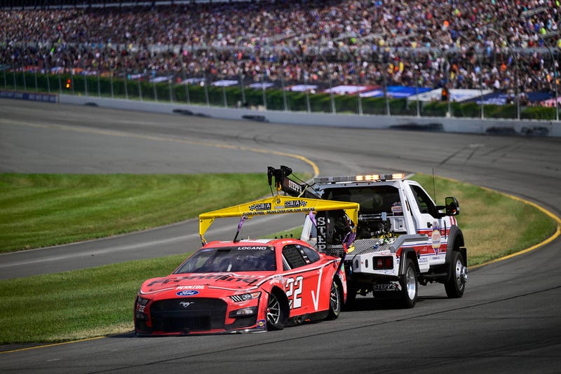Joey Logano is towed back to the pits after an accident during a NASCAR Cup Series auto race at Pocono Raceway, Sunday, July 23, 2023, in Long Pond, Pa. (AP Photo/Derik Hamilton)